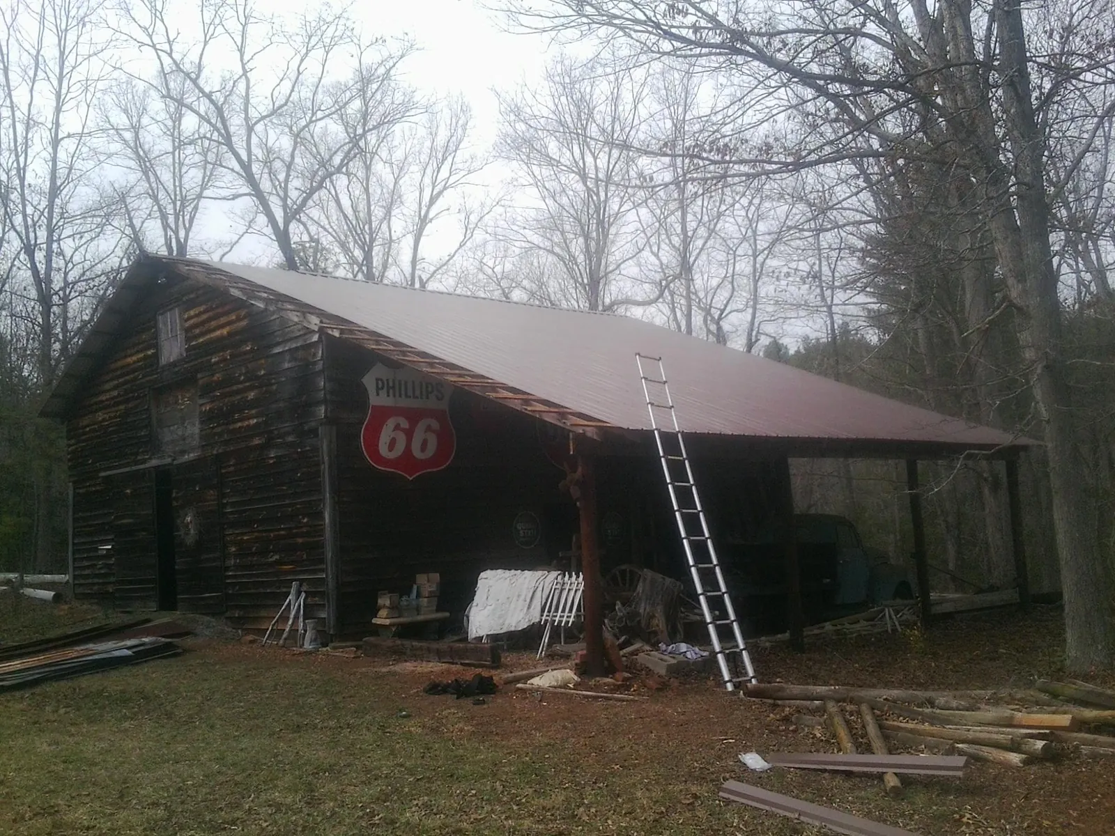 New metal roof on an open sided timber barn with a vintage sign in Oakley
